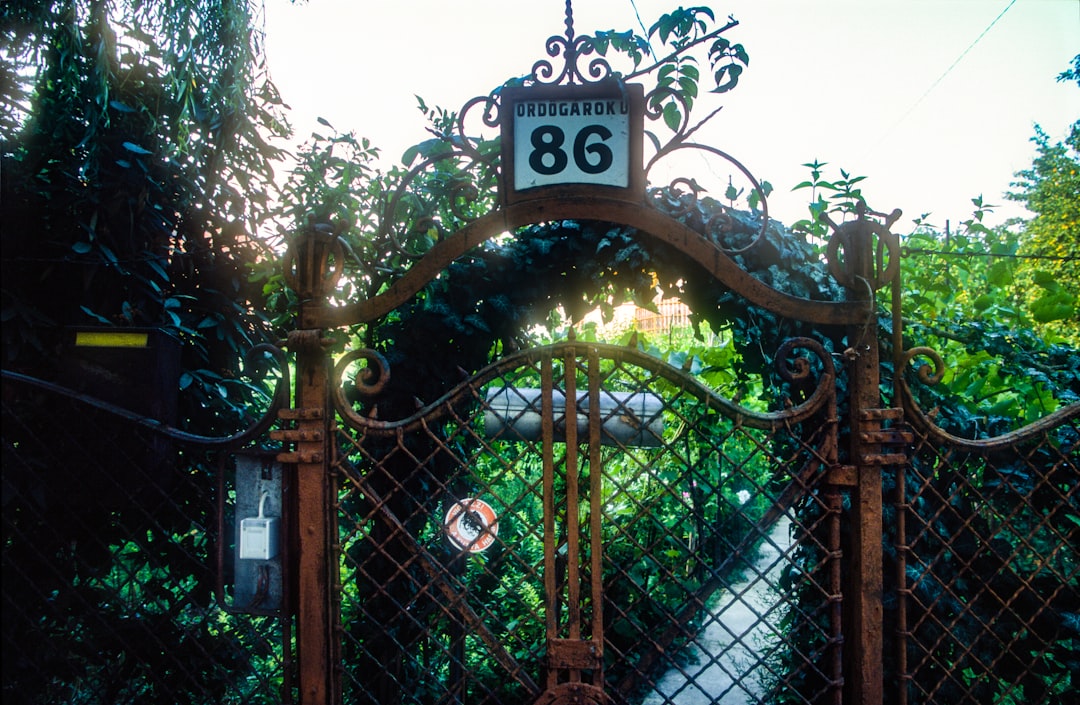 A metal driveway gate being assessed for repair in Pearland